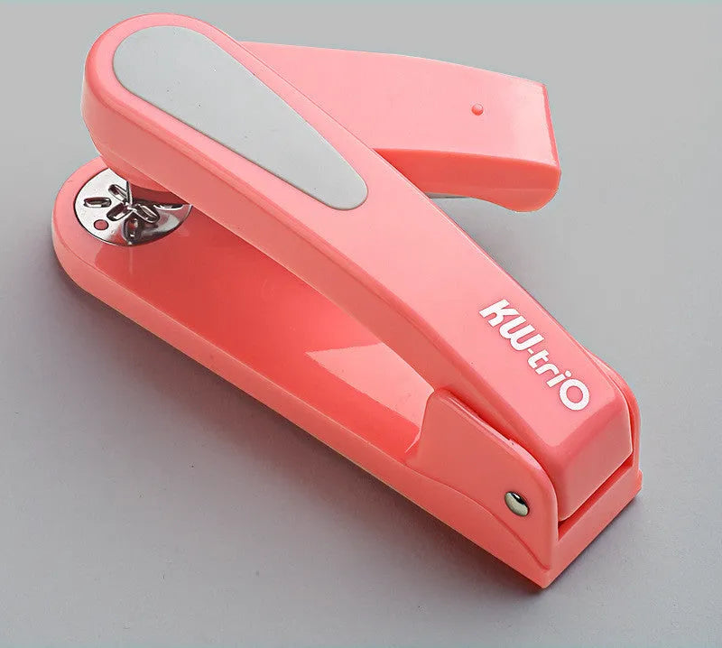 360-degree rotatable student stapler in multiple colours on a desk with paper