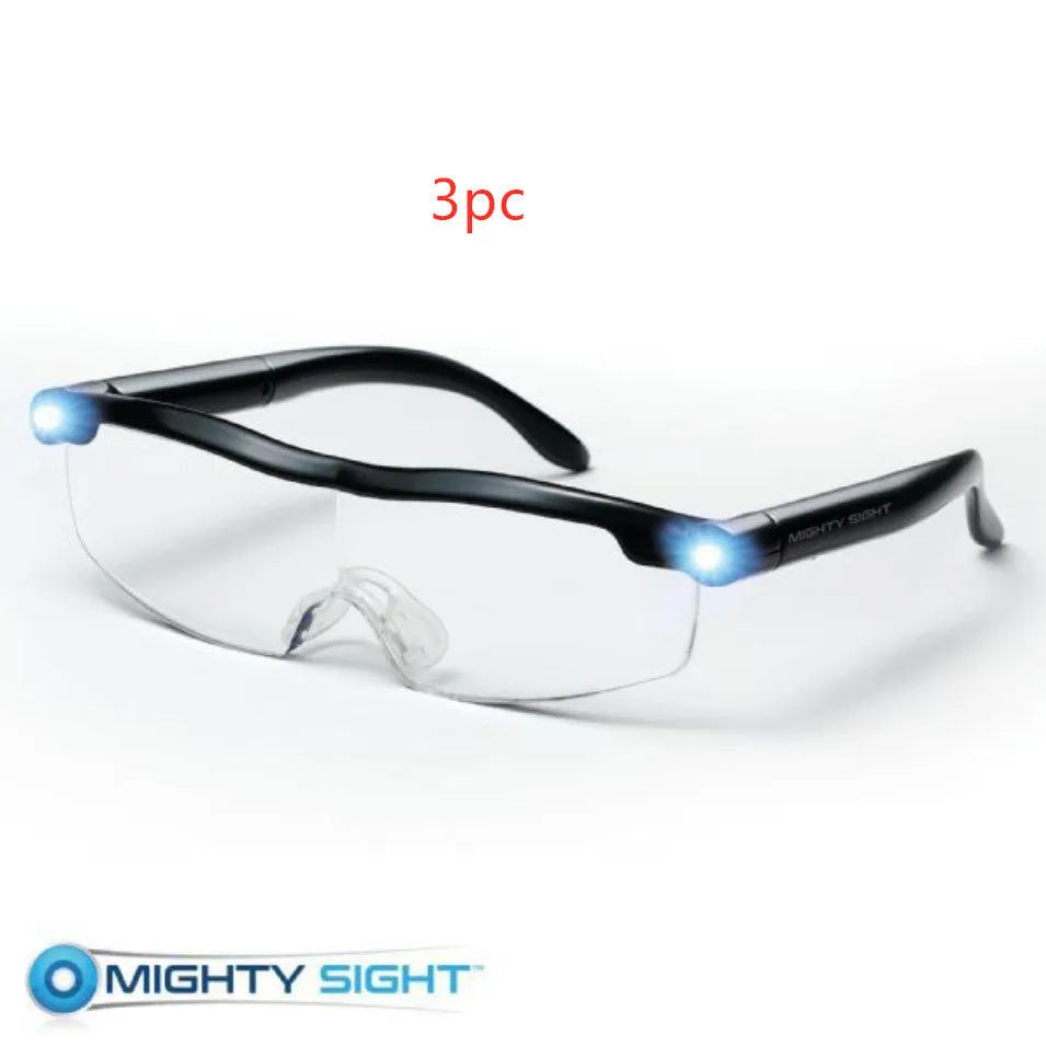 Transparent black USB LED light reading glasses with scheduled timer feature on a desk.