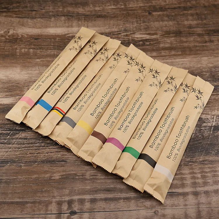 Set of ten bamboo-handled toothbrushes with charcoal bristles in assorted colours on a white background.
