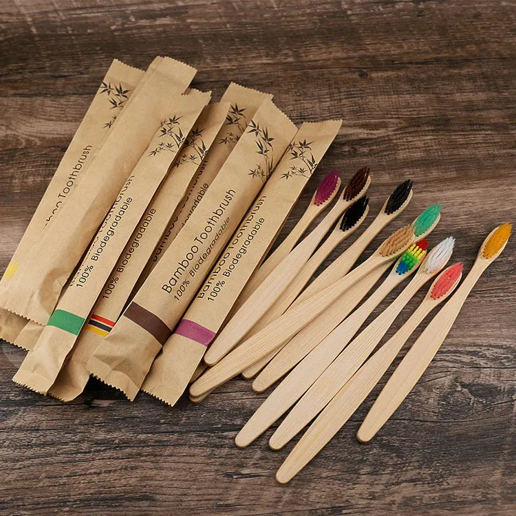 Set of ten bamboo-handled toothbrushes with charcoal bristles in assorted colours on a white background.