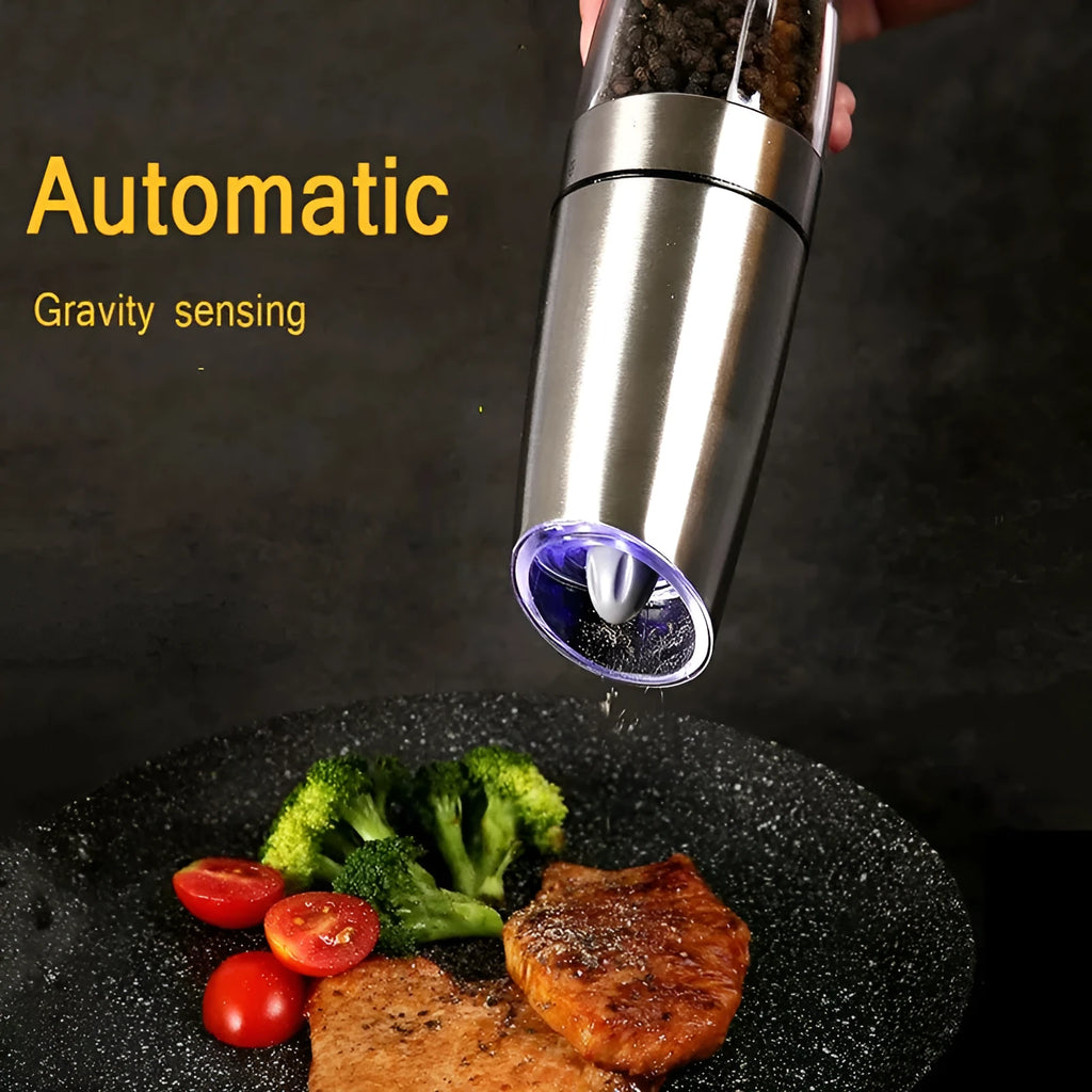 Electric gravity pepper grinder with clear acrylic body and blue LED light on a kitchen countertop