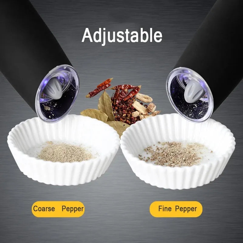 Electric gravity pepper grinder with clear acrylic body and blue LED light on a kitchen countertop