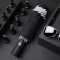 Black automatic reverse umbrella showing inward-folding design with plastic non-slip handle