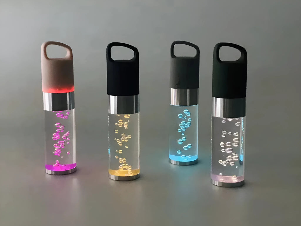 Compact pink Bluetooth speaker with colourful crystal lights on a desk.