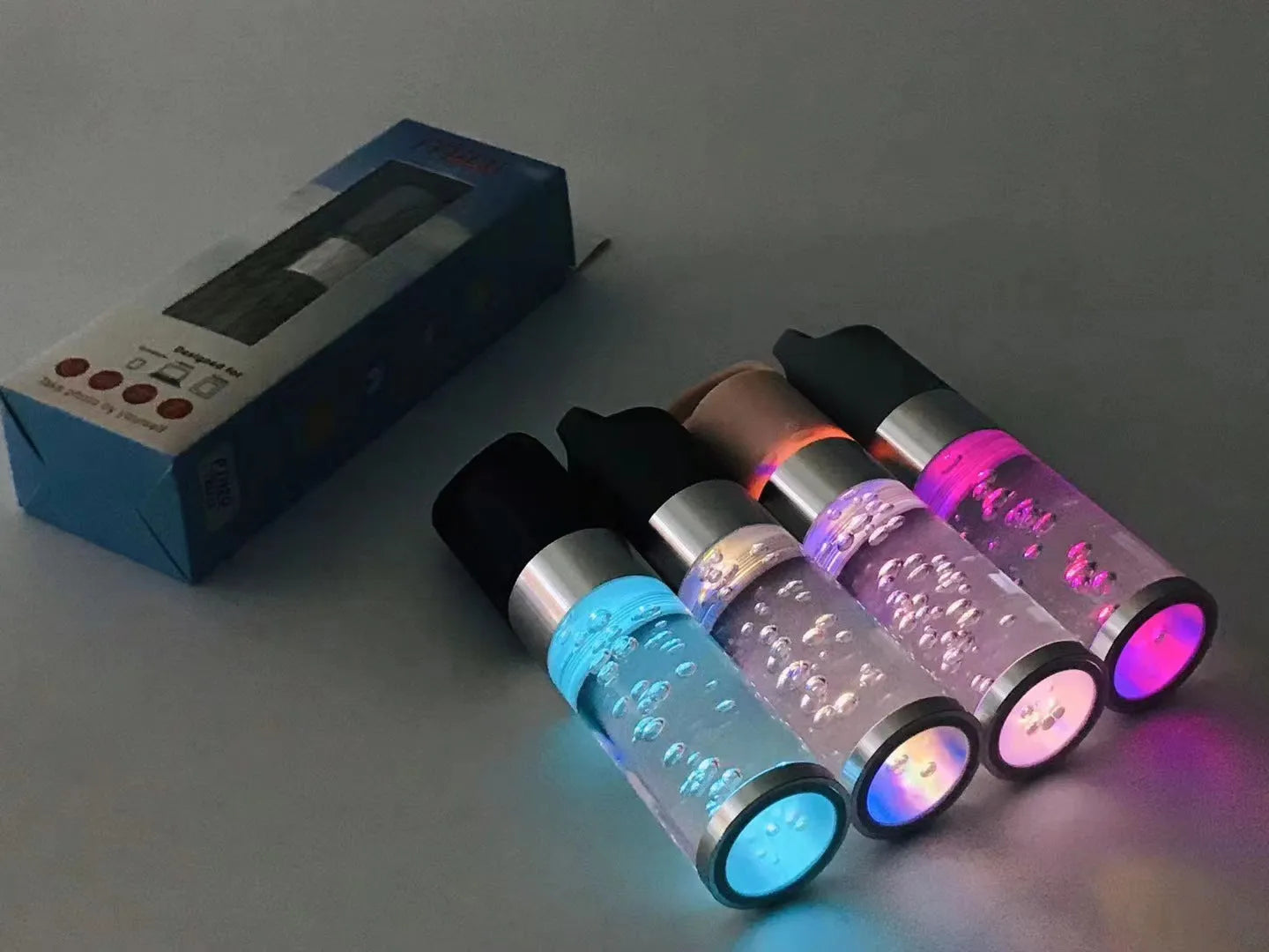 Compact pink Bluetooth speaker with colourful crystal lights on a desk.