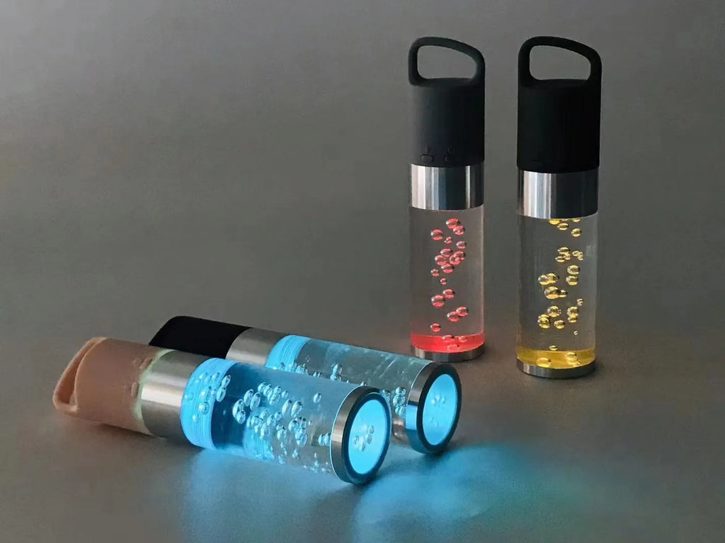 Compact pink Bluetooth speaker with colourful crystal lights on a desk.