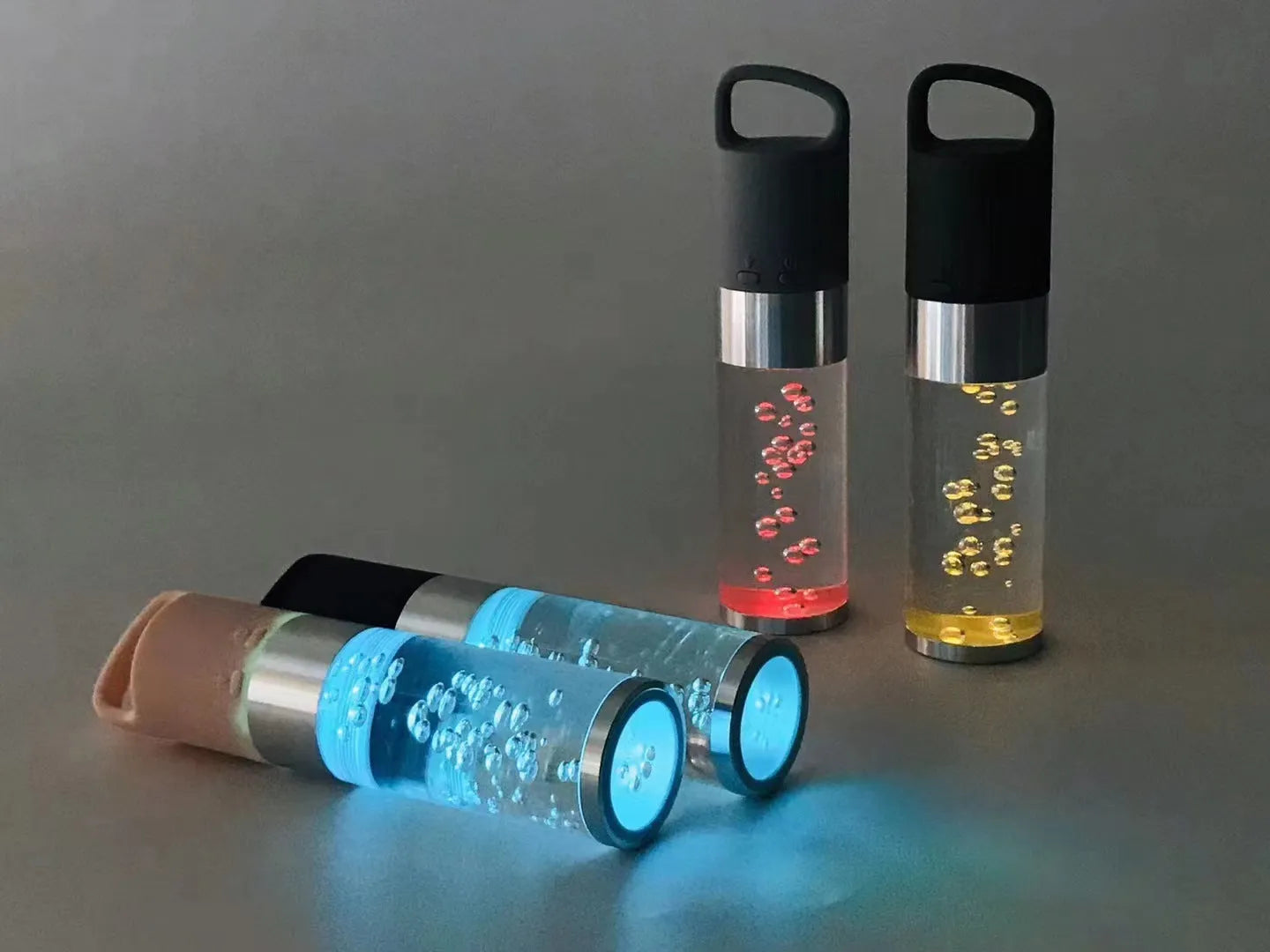 Compact pink Bluetooth speaker with colourful crystal lights on a desk.