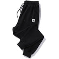 Mens loose fit casual trousers in polyester fabric, nine length, mid waist, small leg opening, available in multiple colours and sizes