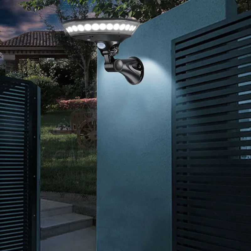 White 360-degree solar-powered outdoor LED light with motion sensor on a stake.