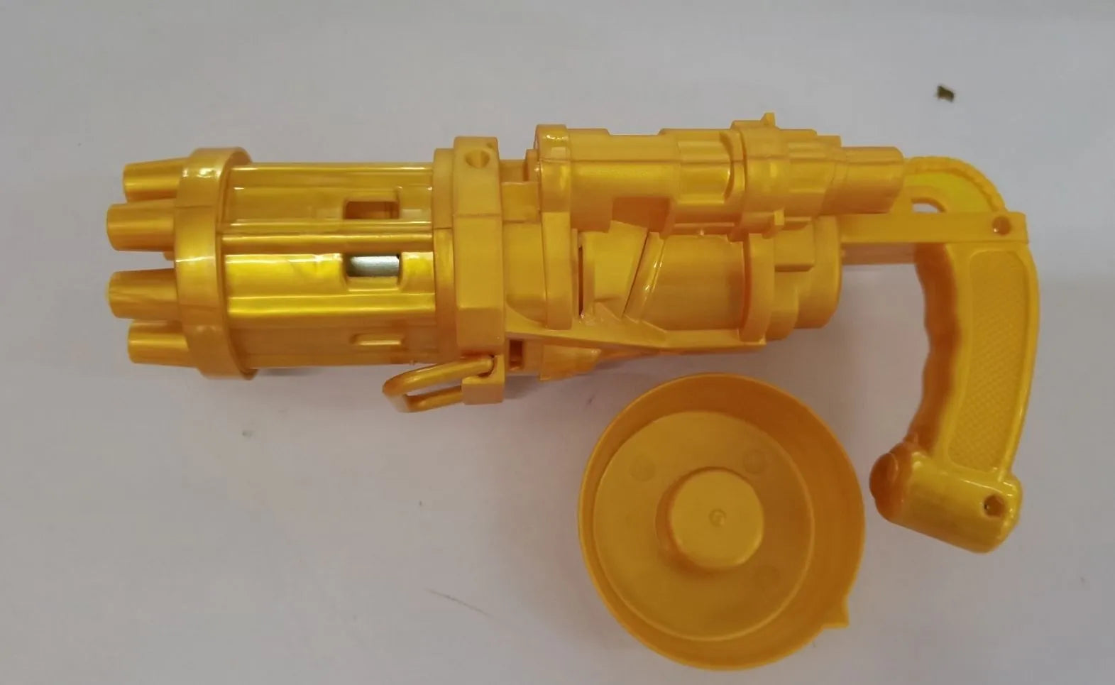 Children's bubble machine gun toy in pink, gold, or black colours with battery compartment and bubble solution.