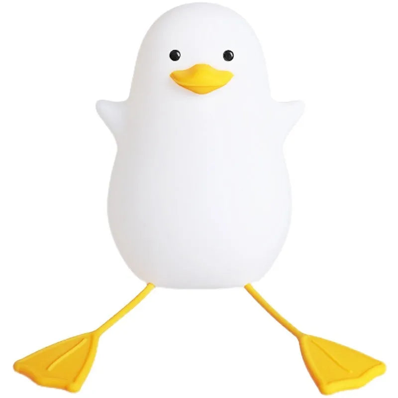 Little Gull rechargeable silicone night light in blue mouth on a bedside table