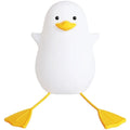 Little Gull rechargeable silicone night light in blue mouth on a bedside table