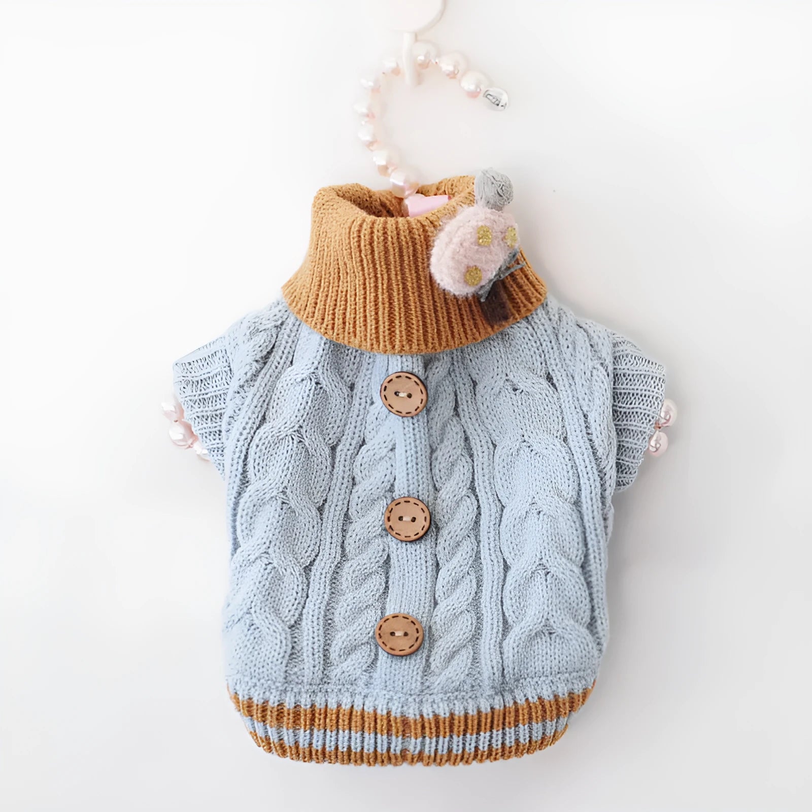 Classic knitted pet sweater for small dogs in a sweet pink colour with twist button fastening