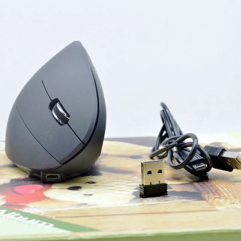 Ergonomic vertical wireless mouse in black with six buttons and four-way scroll wheel on a desk