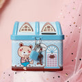 Blue house-shaped tinplate piggy bank on a wooden desk surface.
