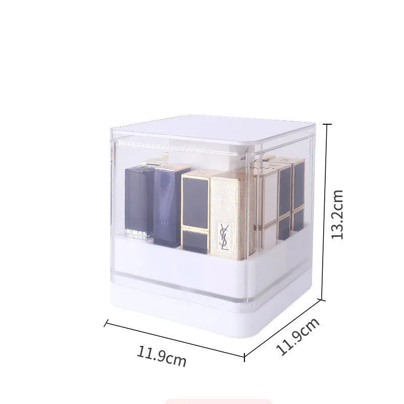Clear pink press-lid lipstick storage box showing 12 individual slots for makeup organisation on a desk.