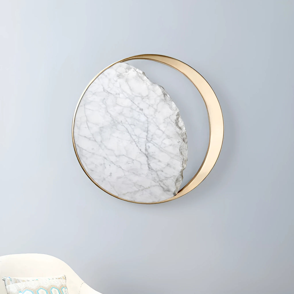 Round marble and copper LED wall lamp with eclipse design, 25 cm diameter, on a textured wall