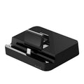 Black base mobile phone to HDMI converter dock for presentations on a desk.