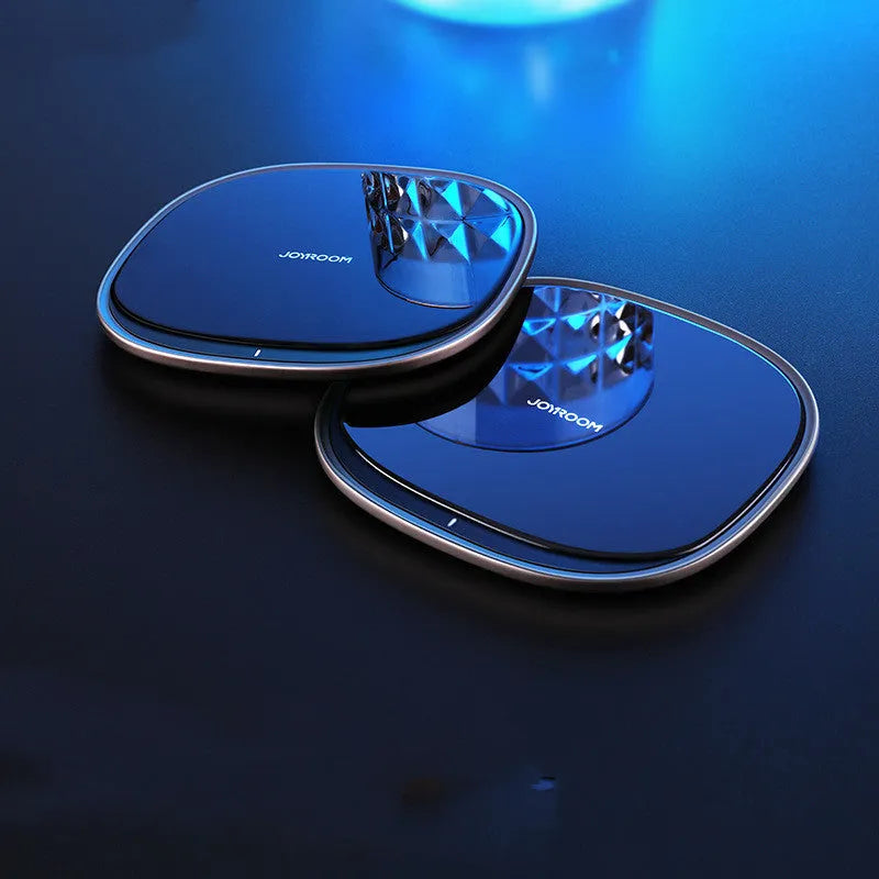 Black 15W Qi wireless charging pad with glass top and zinc alloy base on a desk.