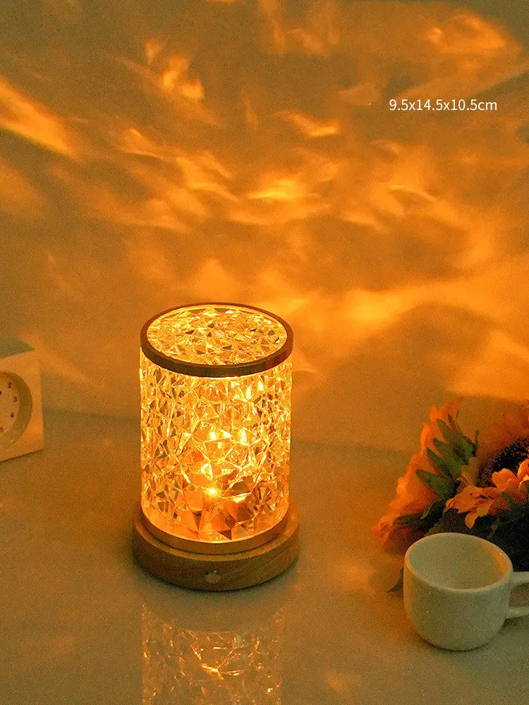 Rotating water ripple touch night light with acrylic body and solid wood base.
