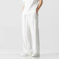 Man modelling beige linen drawstring trousers with a straight-leg cropped fit.
