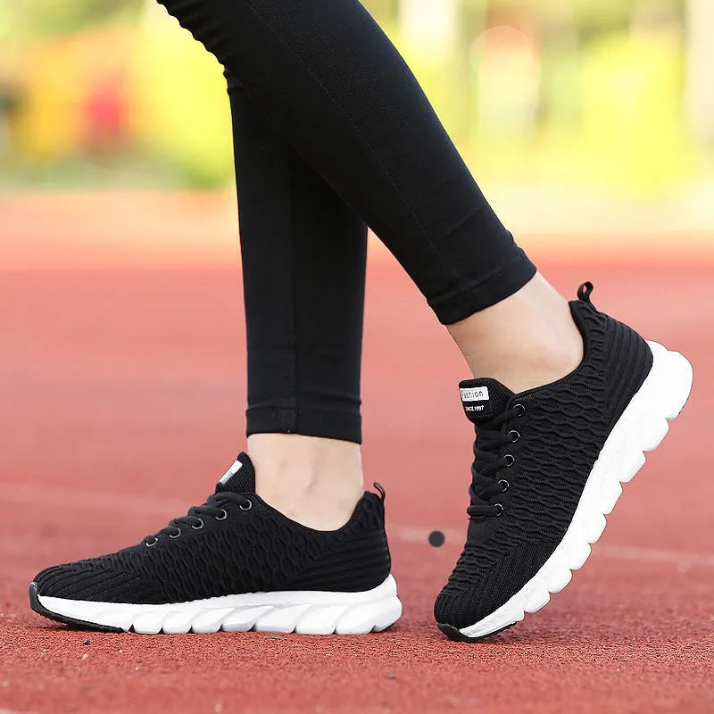 Women's running shoes with fly-weave upper in black, pink and white colour options