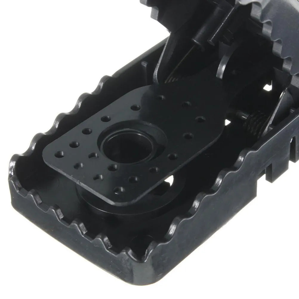Six black plastic snapping mouse traps showing dimensions and smooth surface
