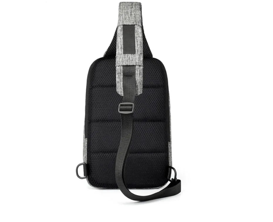 Small square dark blue Oxford cloth chest bag with a single strap and zipper, shown worn across the chest.