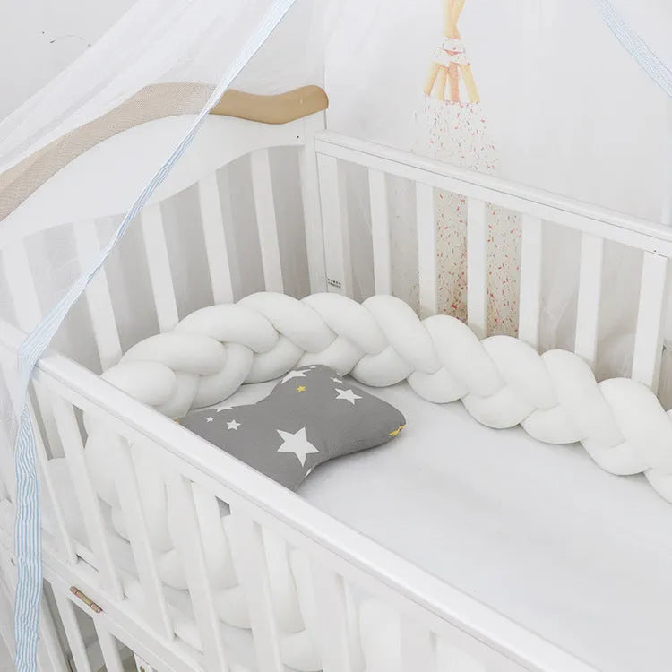 Baby crib bumper braid knot pillow cushion in spandex velvet, shown in a light grey colour