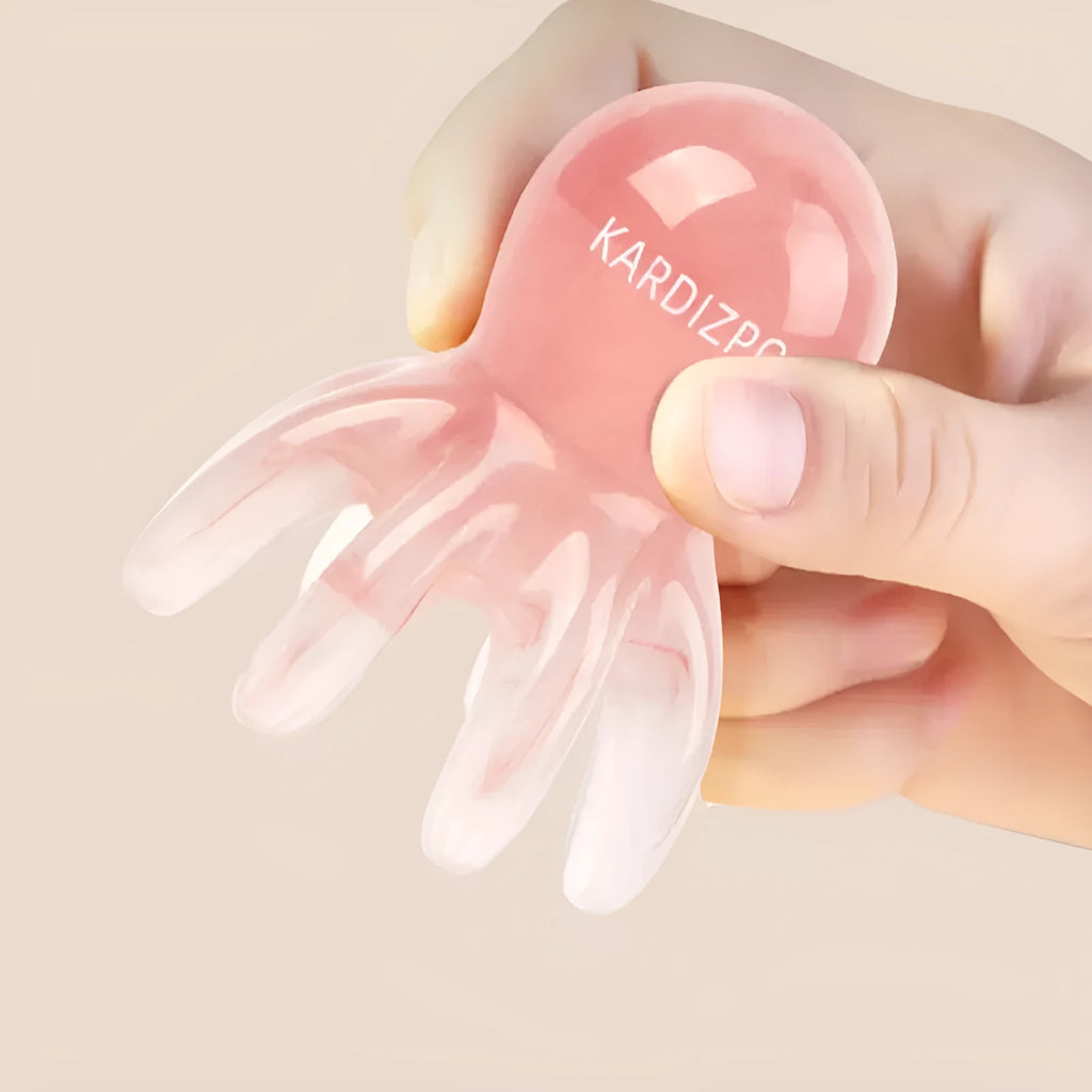 Small pink octopus-shaped periocular massage comb made from natural resin with storage bag