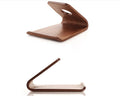 Wooden desk stand holding an iPhone, shown in walnut and white maple wood finishes.