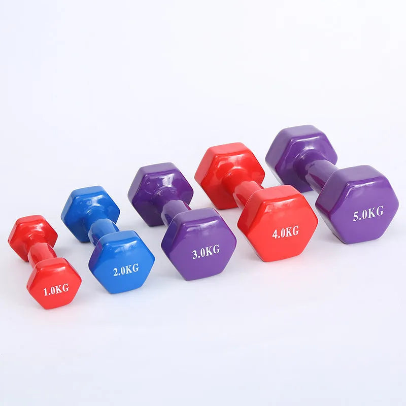 Brightly coloured plastic fitness dumbbells in 0.5kg, 1kg, and 1.5kg weights on a light background