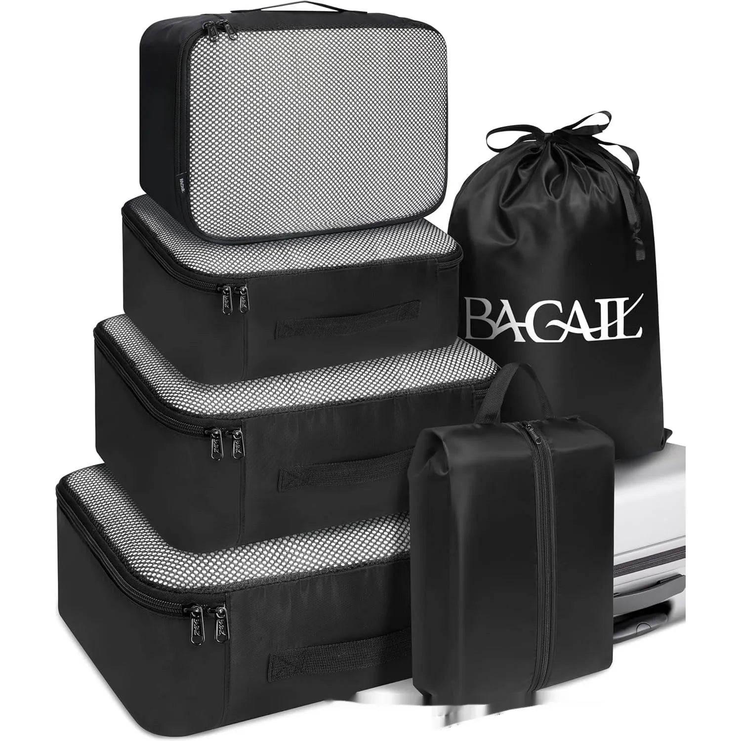 Set of eight cubic-shaped travel packing bags in assorted colours including beige, black, pink, and leopard print patterns.