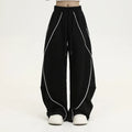 Black pleated wide-leg hip hop trousers with a striped pattern on a mid waist.