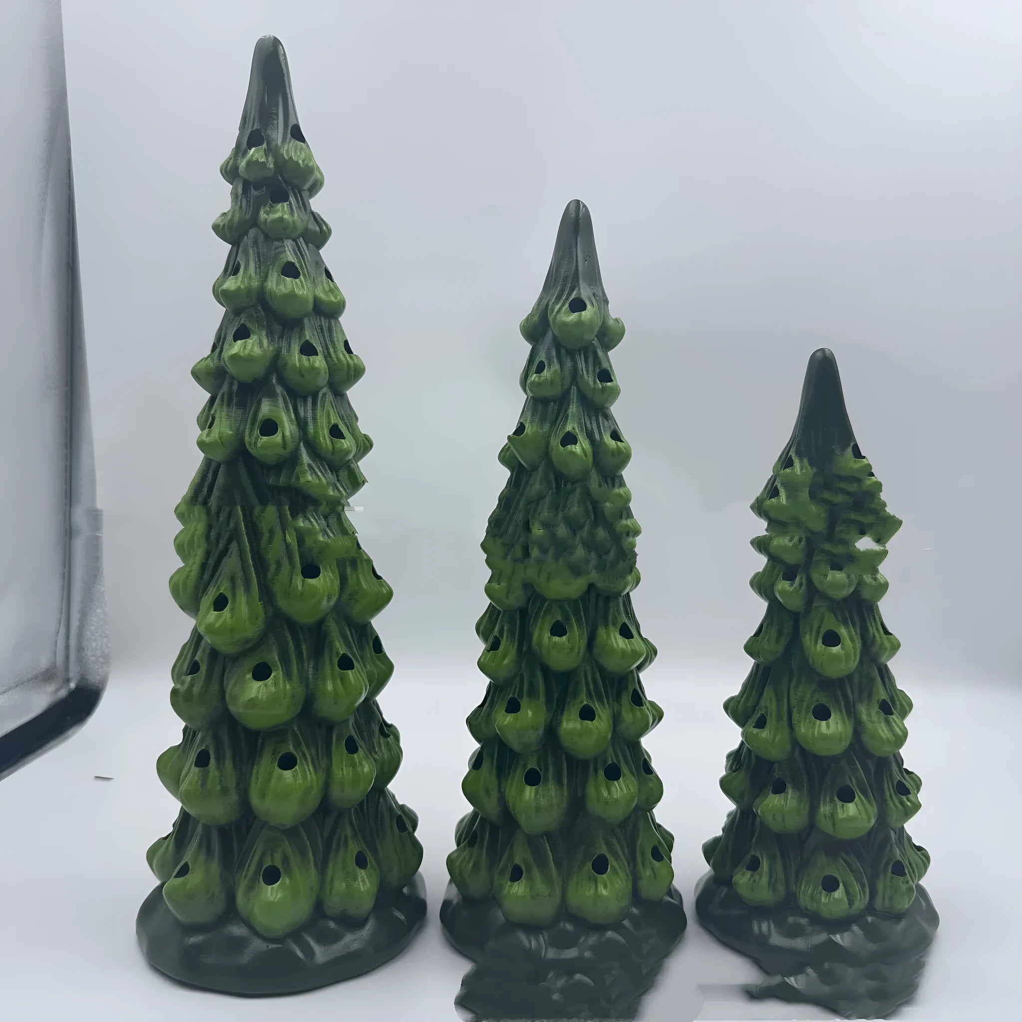 Resin and plastic Christmas tree decorative light ornament in European style, shown in coloured or warm light.