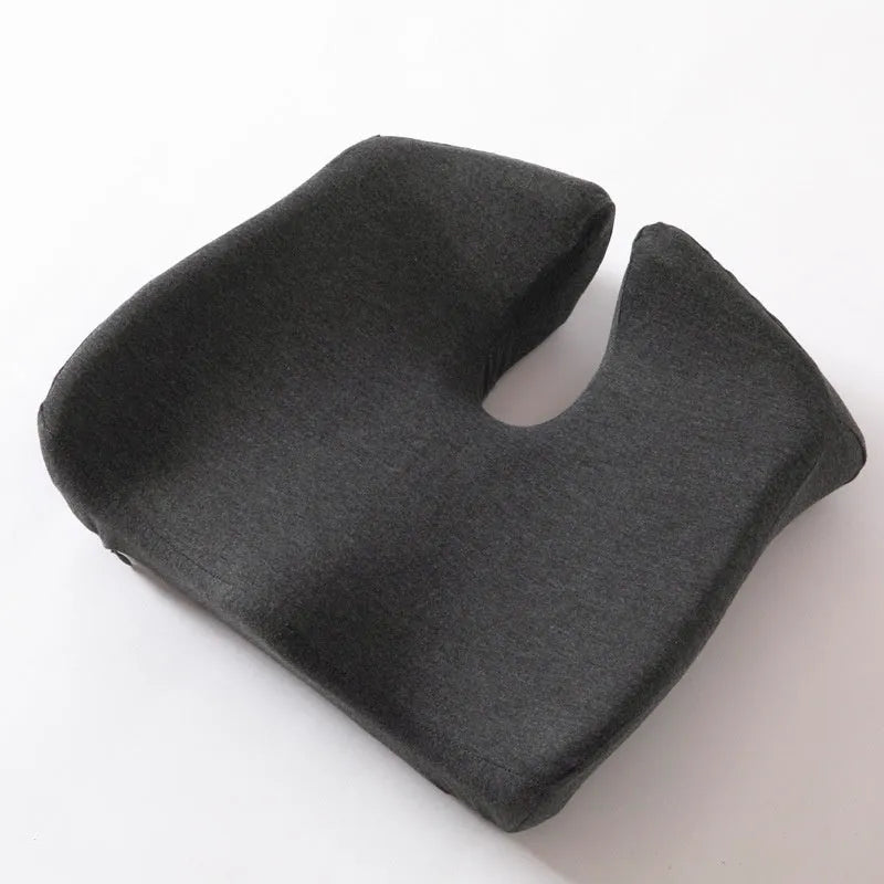 Dark grey memory foam office chair cushion with lumbar support, shown on a black desk chair.