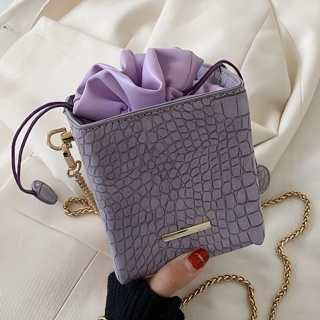 Women's small chain messenger bag in six colour options showing bucket shape and single shoulder strap