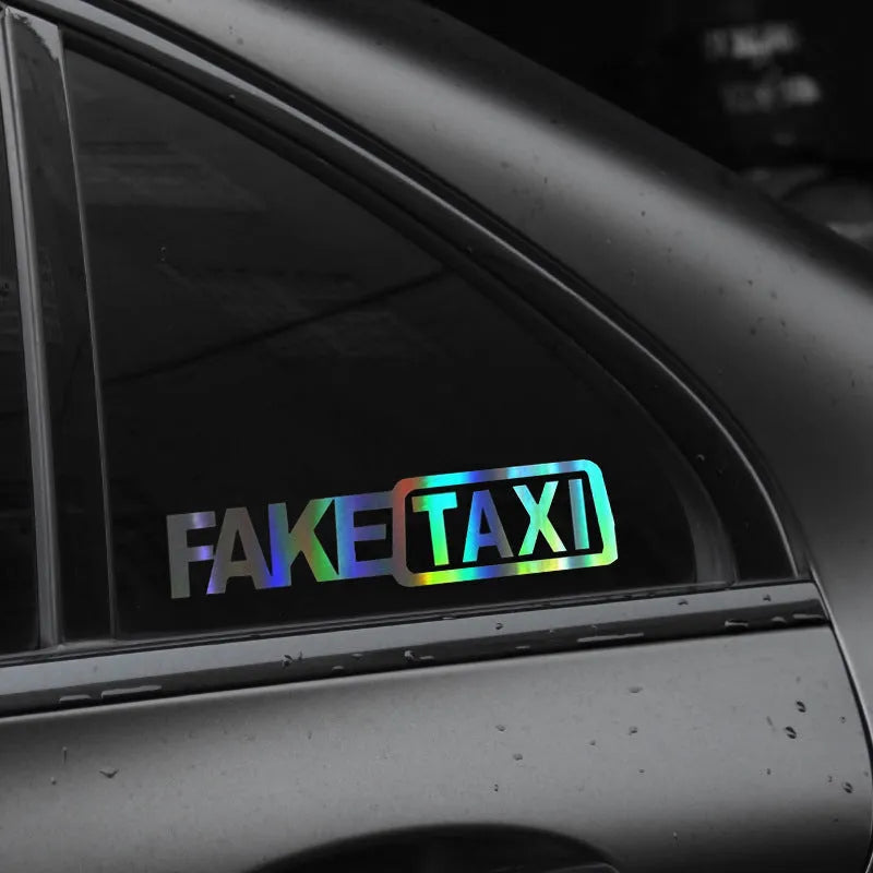 FAKE TAXI car warning sticker in black, white, and yellow, measuring 20cm by 8cm.
