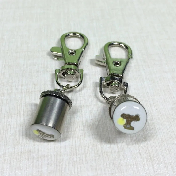LED pet light in silver with copper alloy body showing 60mm length and 12mm width on a dog collar