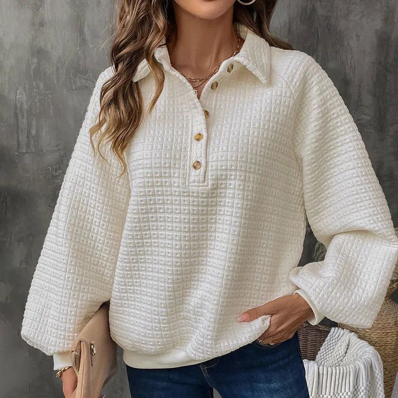 Women's milky white textured polo collar chunky knit sweater laid flat.