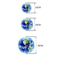 Glow in the dark 3D Earth planet wall sticker in three size options on a wall.
