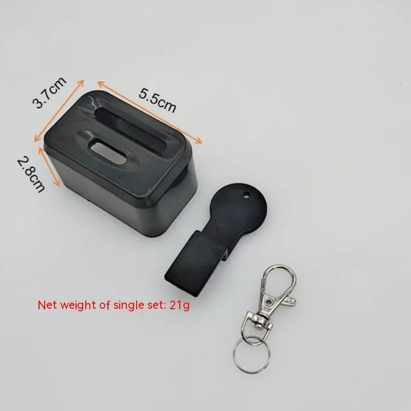 Black ABS plastic seat belt buckle protective cover shown next to vehicle seat belt