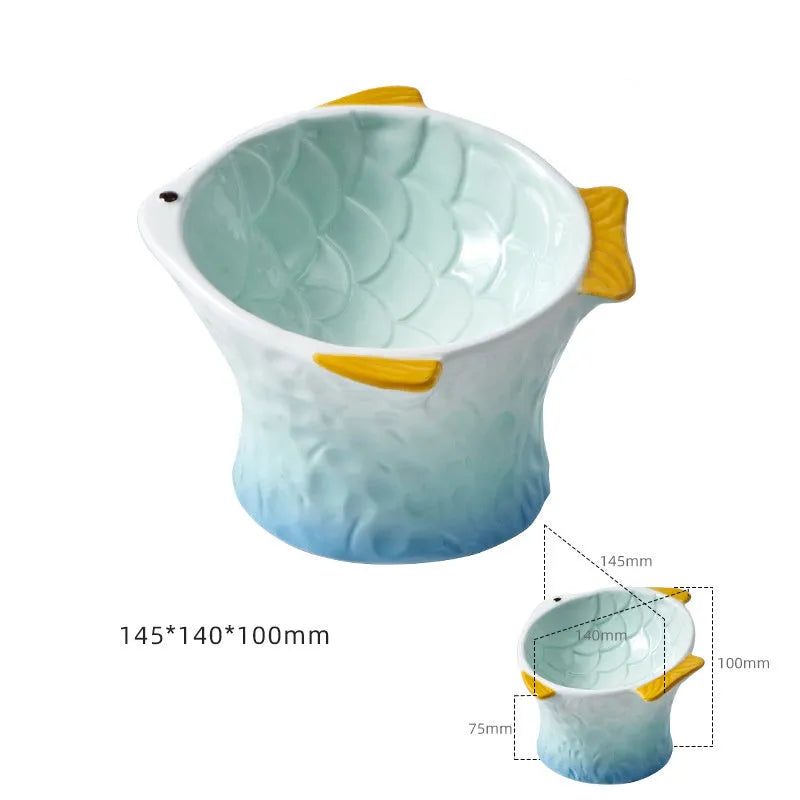 Set of four coloured fish-shaped ceramic cat bowls with a tilted, elevated design on a table.