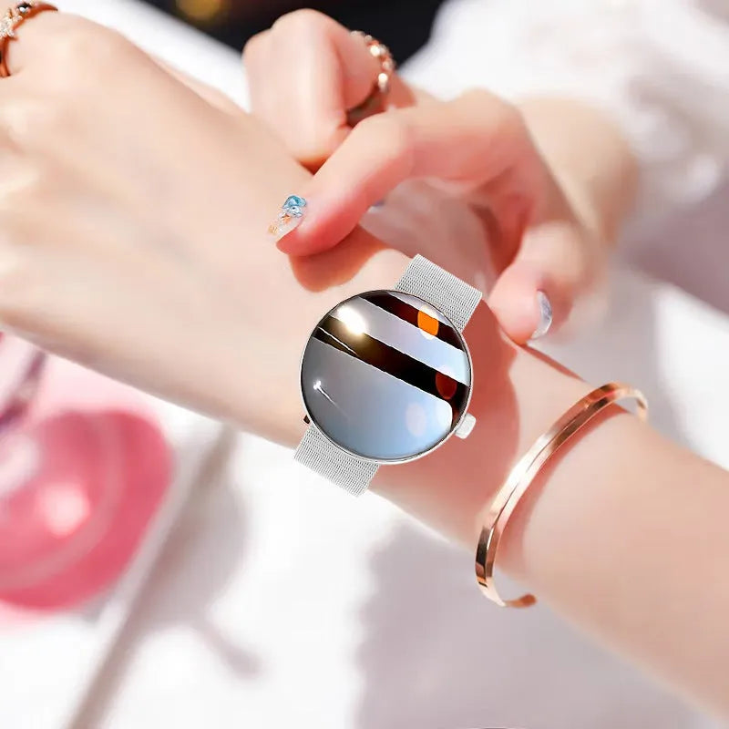 Women's circular smart watch with colour screen and metal strap on wrist