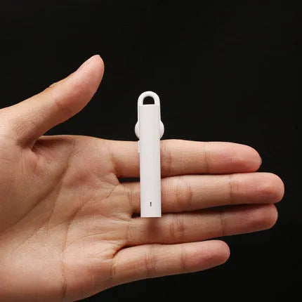 Compact wireless Bluetooth headset in Black, 5.6 cm long, with earpiece and charging port visible