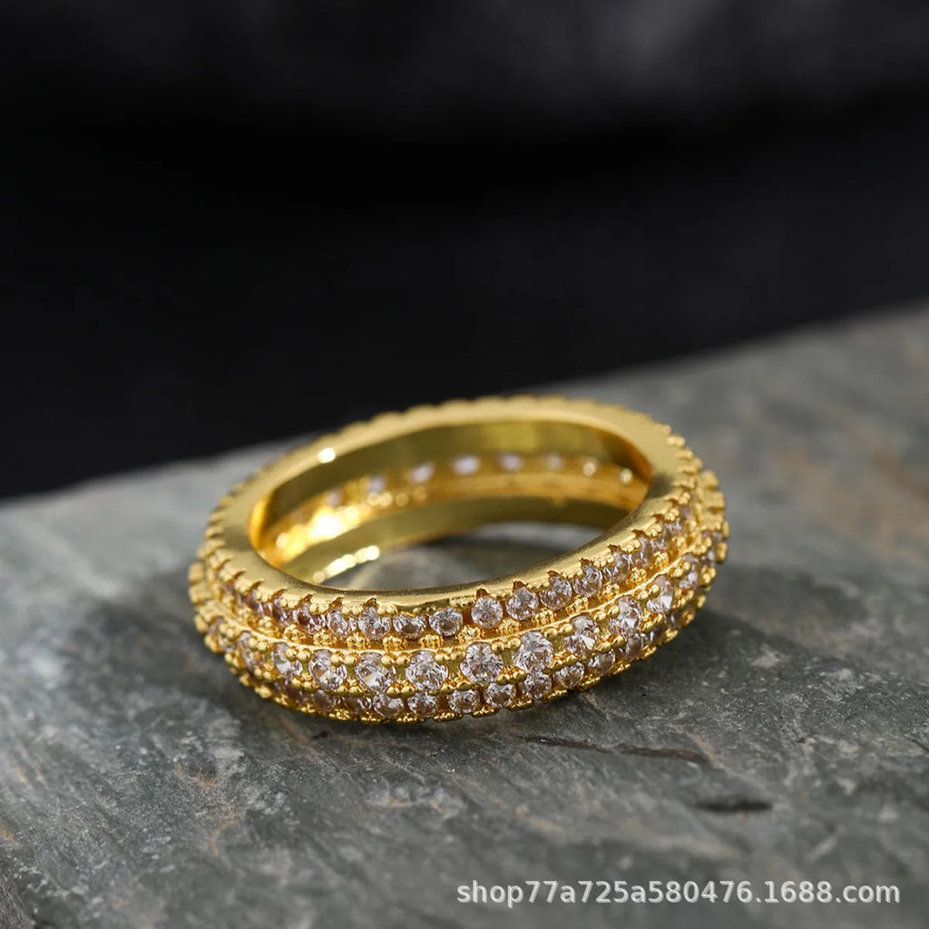 Geometric copper ring with triangle design and zircon stone inlay, shown in a choice of metallic finishes.