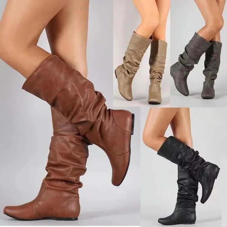 Women's flat black slip-on ankle boots with round toe and high shaft on a rubber sole.