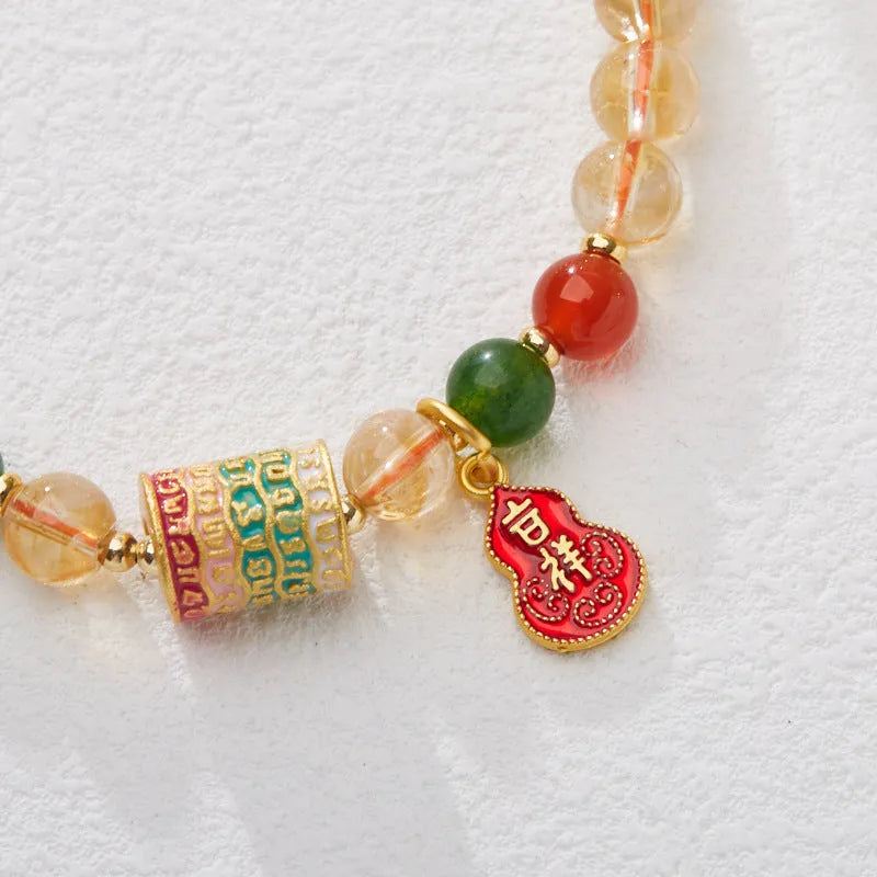Hand-woven citrine five sutra bracelet with 6mm crystal beads showing geometric patterns