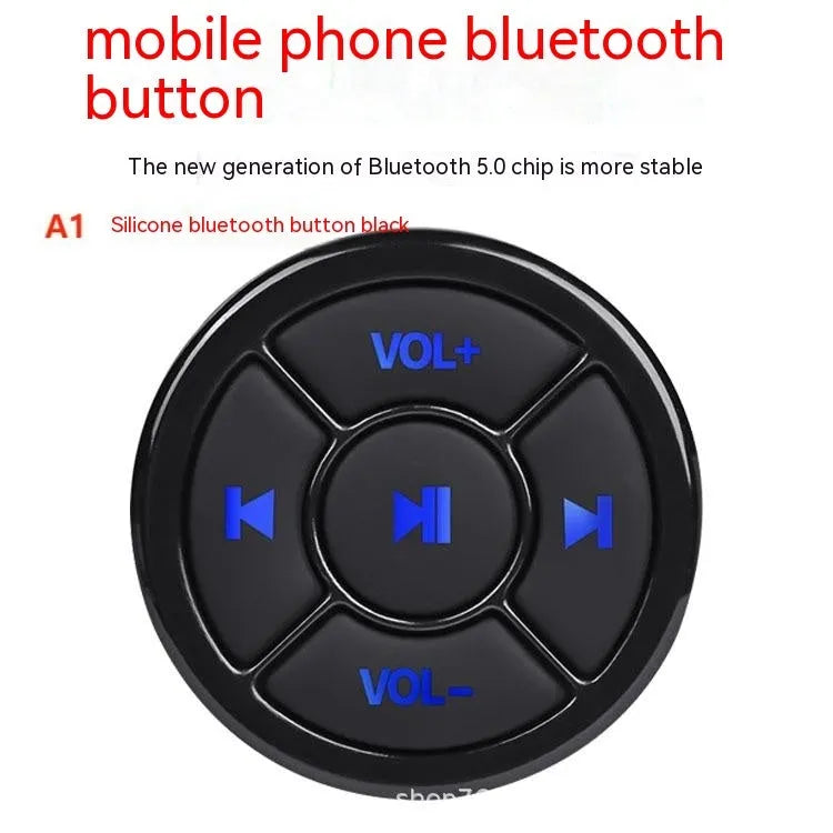36mm black silicone Bluetooth remote control clipped to a car steering wheel for hands-free phone operation