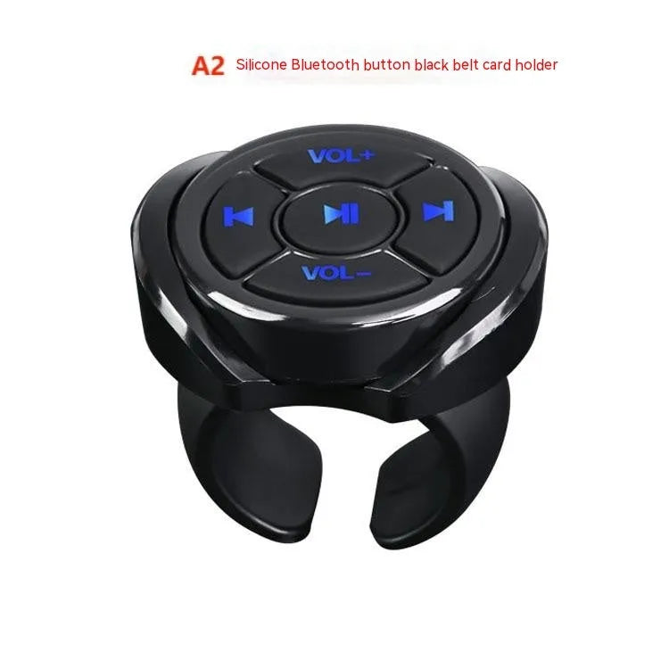 36mm black silicone Bluetooth remote control clipped to a car steering wheel for hands-free phone operation